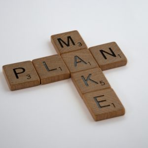 Scrabble tiles spell "Make Plan"
